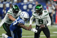 New York Jets quarterback Josh Johnson (9) is chased by Indianapolis Colts' Kemoko Turay (57) during the second half of an NFL football game, Thursday, Nov. 4, 2021, in Indianapolis. (AP Photo/Michael Conroy)