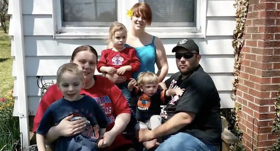 A family shot of Mr Virden and  Ms Jones sitting down with their children.