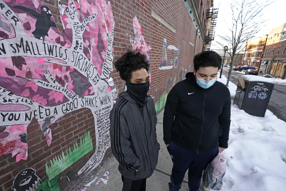 High school sophomores Jose Cruz, left, and Mannix Resto, both of Chelsea, Mass., speak about the COVID-19 pandemic and how it has impacted them on Feb. 10, 2021. Resto fears the state's slow rollout of the vaccine will continue to prevent students from attending classes in-person. The 15-year-old says no one in his family has been vaccinated yet. "I just want to know how much longer it's going to last," Resto said. (AP Photo/Elise Amendola)