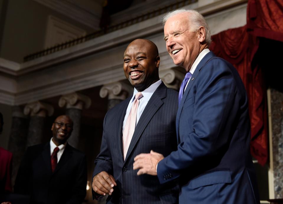 Vice President Joe Biden, right, poses for a photo with Sen. Tim Scott, D-S.C., following his mock swearing-in ceremony in the Old Senate Chamber on Capitol Hill in Washington, Tuesday, Dec. 2, 2014. (AP Photo/Susan Walsh)