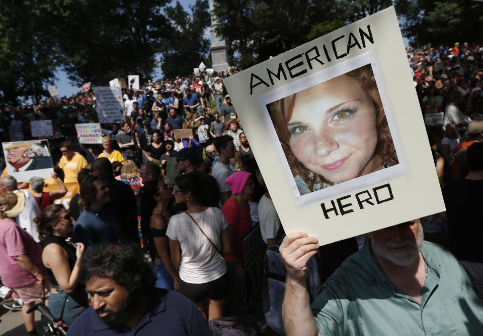 FILE - In this Aug. 19, 2017, file photo, a protester holds a photo of Heather Heyer on Boston Common at a "Free Speech" rally organized by conservative activists in Boston. James Alex Fields Jr., a white supremacist who killed Heyer, when he rammed his car into a crowd of counterprotesters at the 2017 Unite the Right rally in Charlottesville has been fined for threatening a correctional officer and brandishing a “dangerous weapon” at the prison where he is serving a life sentence. (AP Photo/Michael Dwyer, File)