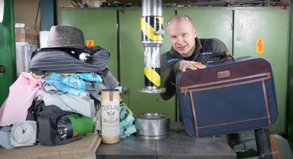 Lauri Vuohensilta (above) and Hanna Korpisaari crushed a week’s worth of travel items into a carry-on suitcase with an assist from a 150-ton hydraulic press. YouTube/Hydraulic Press Channel