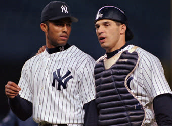 Former Yankees catcher and current manager Joe Girardi talks with Mariano Rivera after the Yankees got out of a bases-loaded jam during a 5-4 victory over the Rangers in 1997