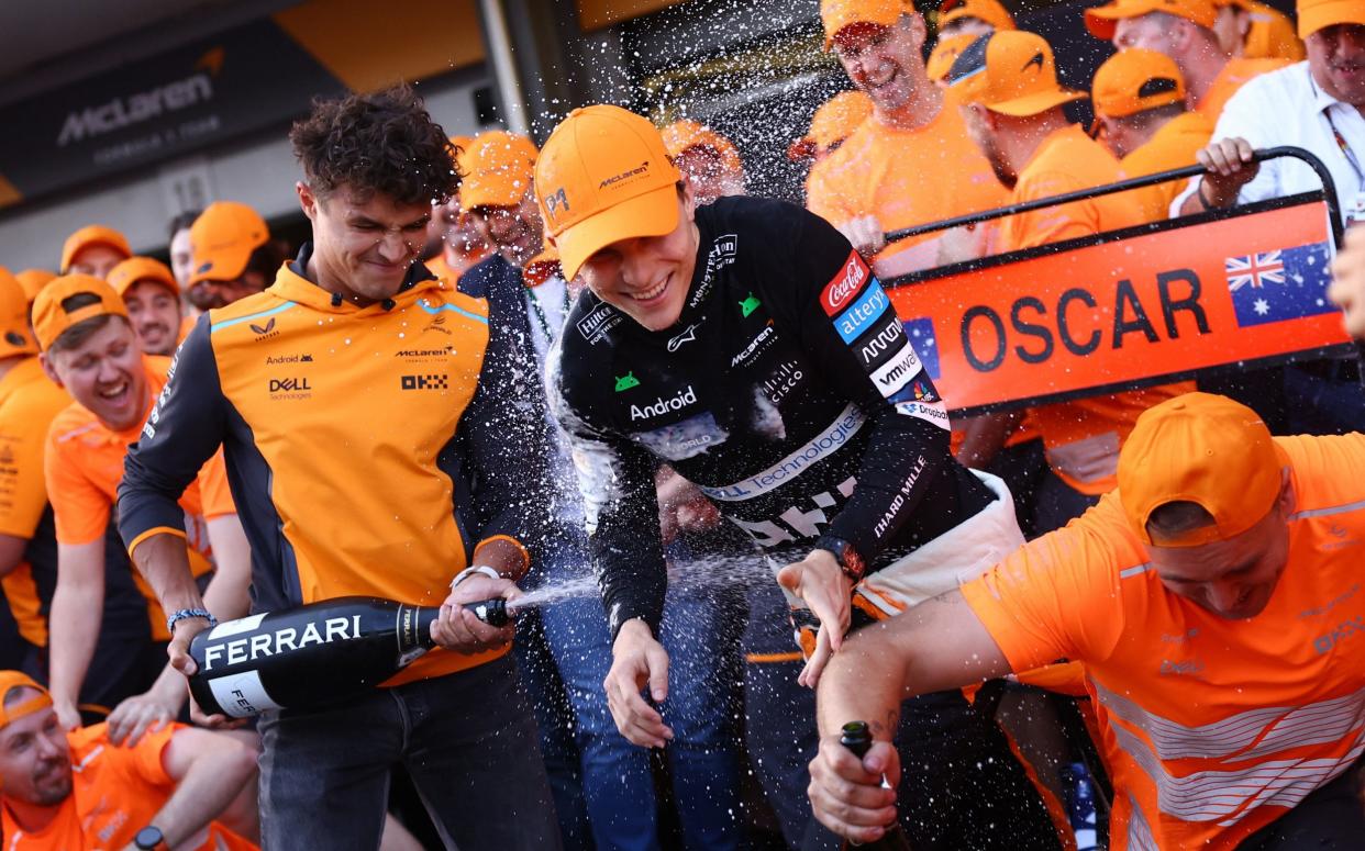 McLaren's Oscar Piastri celebrates with Lando Norris and his team in the garage after winning the Azerbaijan Grand Prix