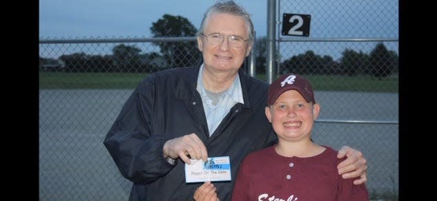 Art "Pinky" Deras posing with his son, Adam Deras, after Adam won MVP at a baseball game.