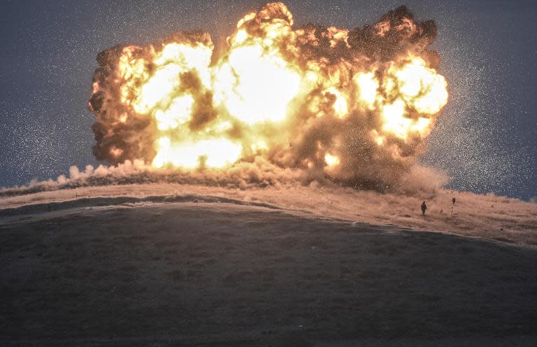 Militants of Islamic State (IS) stand just before an air strike on Tilsehir hill near Turkish border on October 23, 2014, at Yumurtalik village, in Sanliurfa province