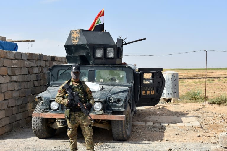 Iraqi troops guard a military position retaken from Kurdish forces in the Kirkuk province town of Taza Khurmatu on October 13, 2017