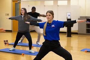 UWG students follow the lead of their campus yoga instructor.