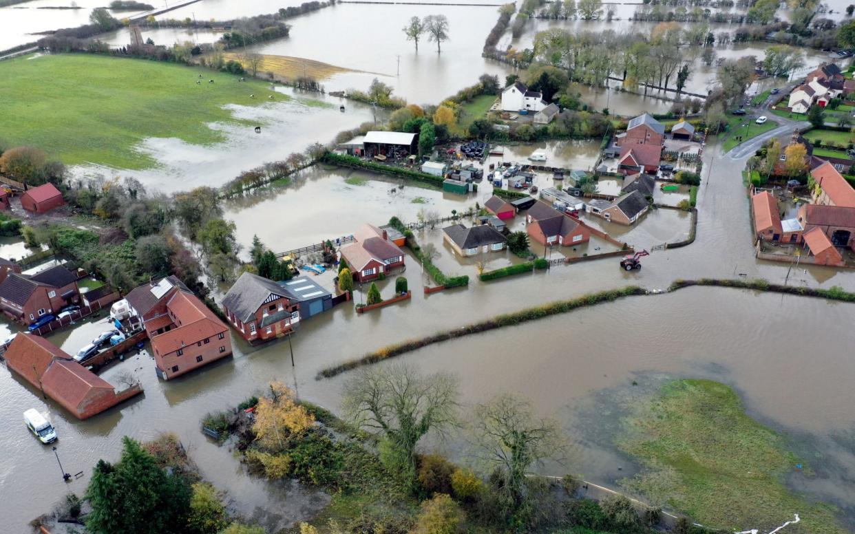 Locals in Fishlake, Yorkshire have had to wade through waist-deep water  - PA