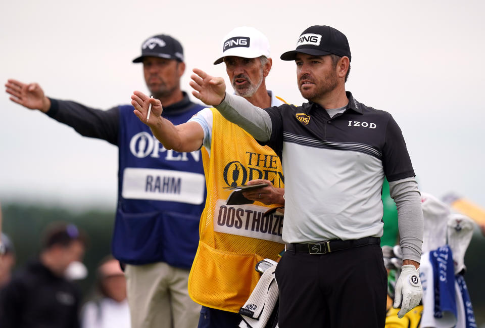 <p>South Africa's Louis Oosthuizen lines up a shot on the 16th tee with the help of his caddie during day one of The Open at The Royal St George's Golf Club in Sandwich, Kent. Picture date: Thursday July 15, 2021.</p>
