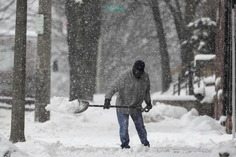 A man shovels as a winter storm arrives Friday, Jan. 12, 2024, in Milwaukee. (AP Photo/Morry Gash)