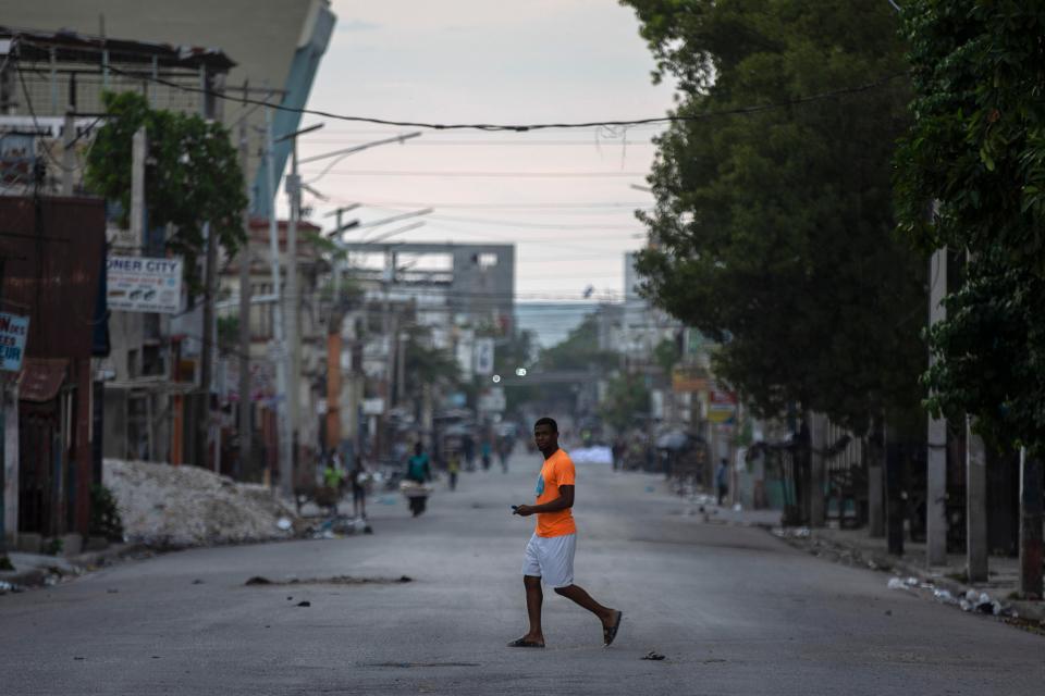 A man walks through a street empty of traffic due to a general strike in Port-au-Prince, Haiti, Monday, Oct. 18, 2021. 