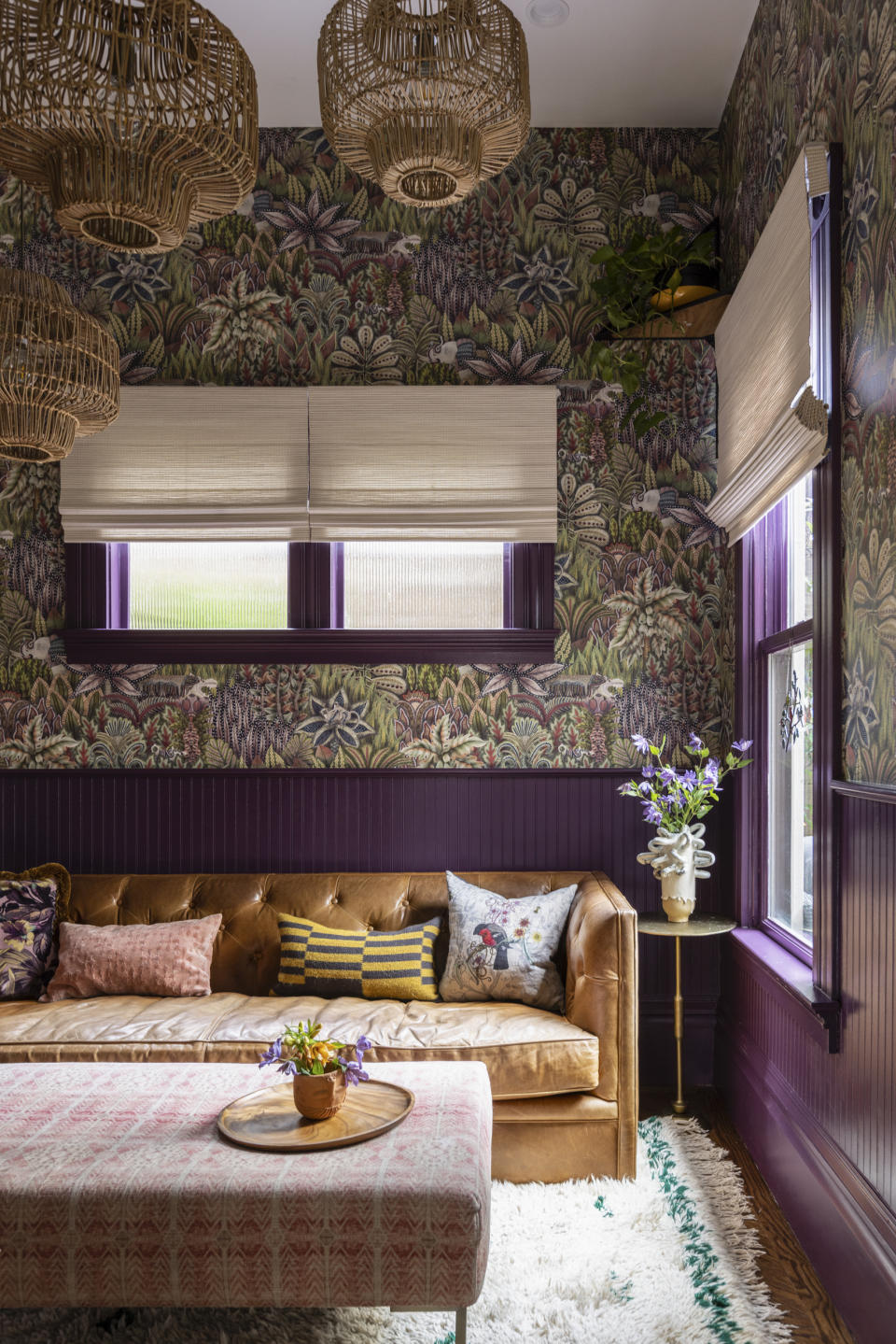 This image provided by SENCreative shows a family room. Moody hues are too-often decried in design as heavy or low-energy,' says designer Noz Nozawa, " but I think the richness of moody colors is what carries a room." This San Francisco family room was painted Benjamin Moore's Autumn Purple. (SENCreative/Lauren Andersen via AP)