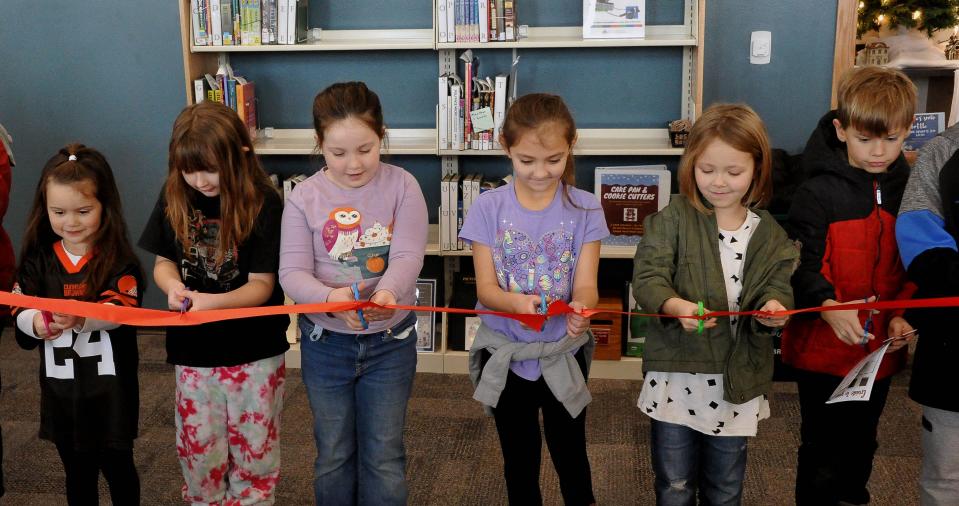 School children had a turn at cutting the ribbon at the dedication of Rittman's new branch library dedication.