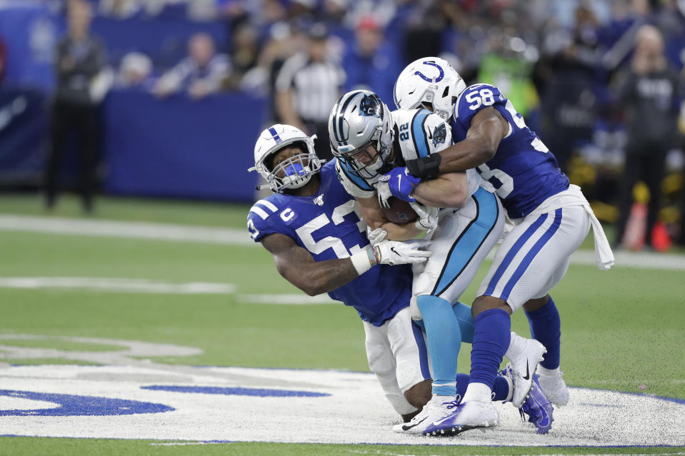 Carolina Panthers' Christian McCaffrey (22) is tackled by Indianapolis Colts' Darius Leonard (53) and Bobby Okereke (58) during the second half of an NFL football game, Sunday, Dec. 22, 2019, in Indianapolis. (AP Photo/Michael Conroy)