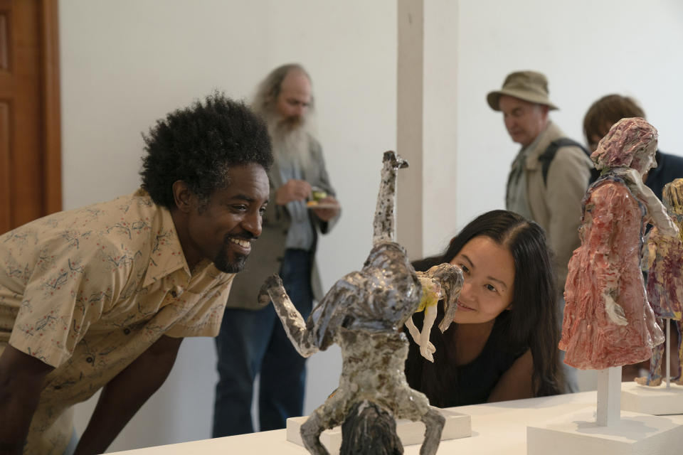 This image released by A24 shows André Benjamin, left, and Hong Chau in a scene from "Showing Up." (Allyson Riggs/A24 via AP)