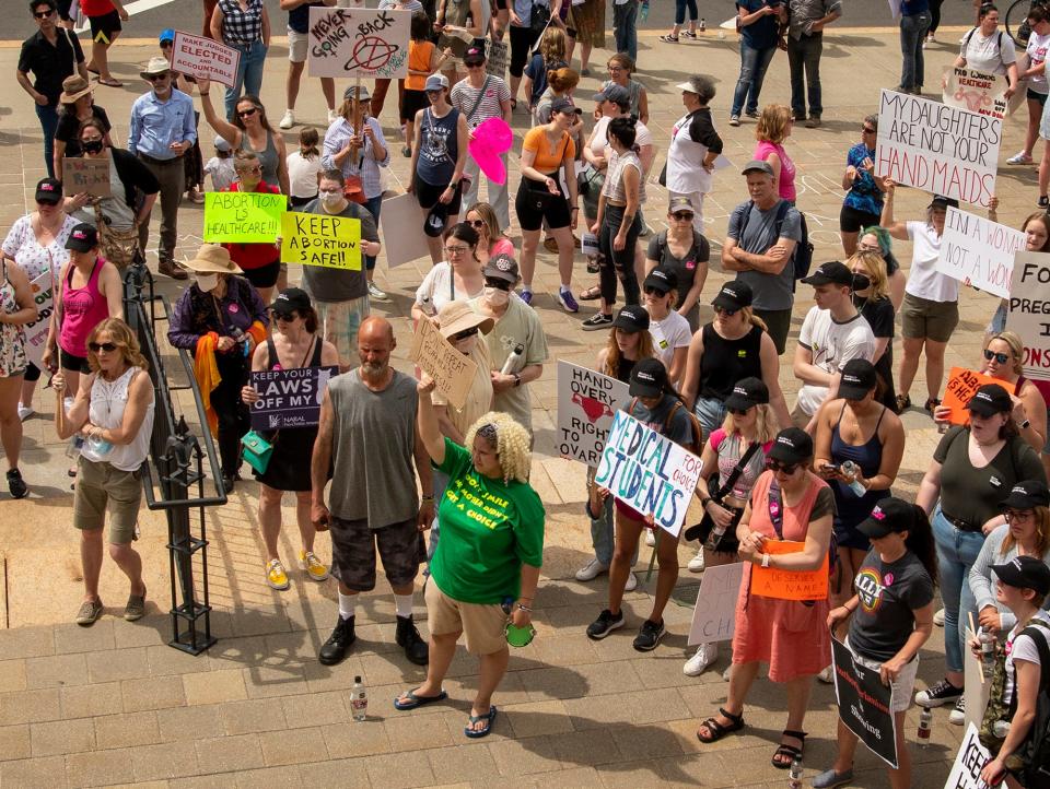 Liz Callan of Worcester, center with green shirt, and other protesters rally for abortion rights Saturday in front of City Hall.