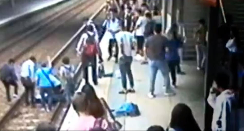 Brave commuters risked their lives by jumping on to the track to try and help the man, while signalling the train driver to stop in time. Source: 7 News  