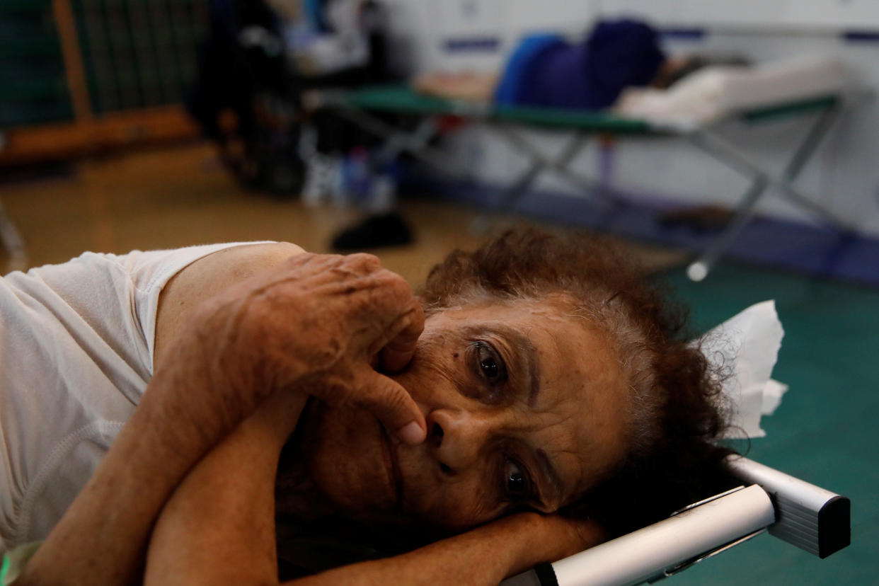 Hilda Colon wakes up after sleeping in a shelter set up at the Pedrin Zorrilla coliseum, after Hurricane Maria destroyed the region in San Juan, Puerto Rico. (Photo: Carlos Garcia Rawlins / Reuters)