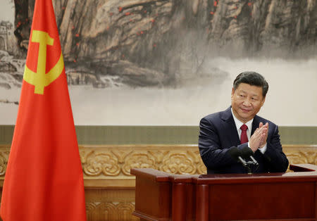 China's President Xi Jinping claps after his speech as he and other new Politburo Standing Committee members meet with the press at the Great Hall of the People in Beijing, China October 25, 2017. REUTERS/Jason Lee