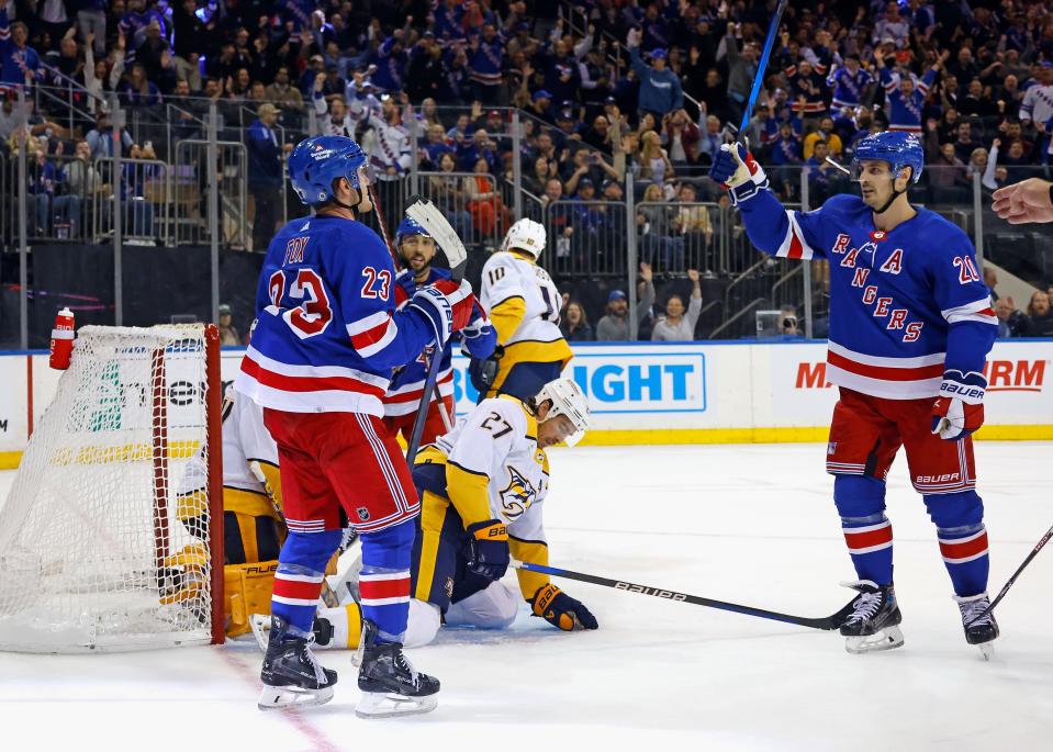 NEW YORK, NEW YORK - OCTOBER 19: Adam Fox #23 of the New York Rangers celebrates his second period powerplay goal against the Nashville Predators and is joined by Chris Kreider #20 at Madison Square Garden on October 19, 2023 in New York City.