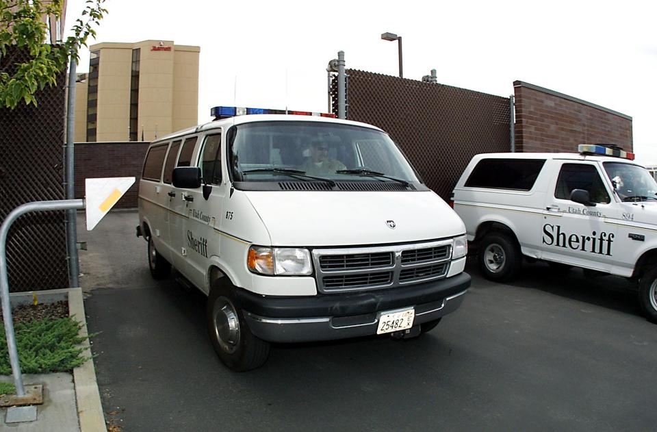 Pictured are two Utah County Sheriff's vans leaving Fourth District Court on August 24, 2001, in Provo, Utah.
