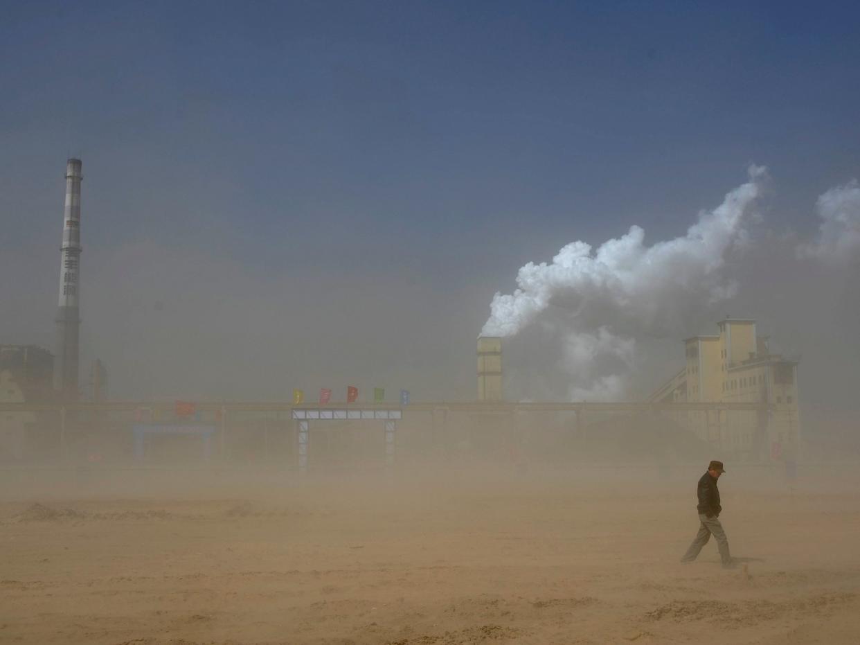 A coal plant partly obscured by a dust storm in China's Ningxia Hui autonomous region; the country is one of the worst offenders when it comes to emissions: Reuters