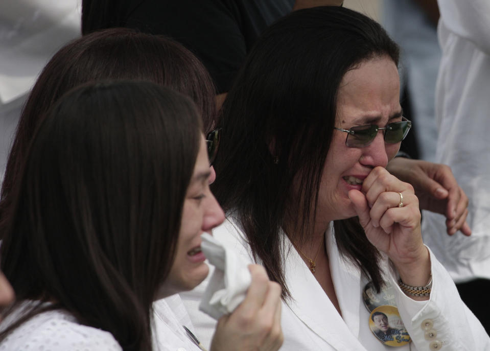 Relatives and friends grieve during funeral rites of the country’s "King of Comedy", Rodolfo Vera Quizon Sr., locally known as "Dolphy" at a cemetery in Taguig, south of Manila, Philippines on Sunday July 15, 2012. Quizon starred in more than 200 films in his 66-year career. The 83-year-old died Tuesday of multiple organ failure, kidney ailments and complications from pneumonia. (AP Photo/Aaron Favila)