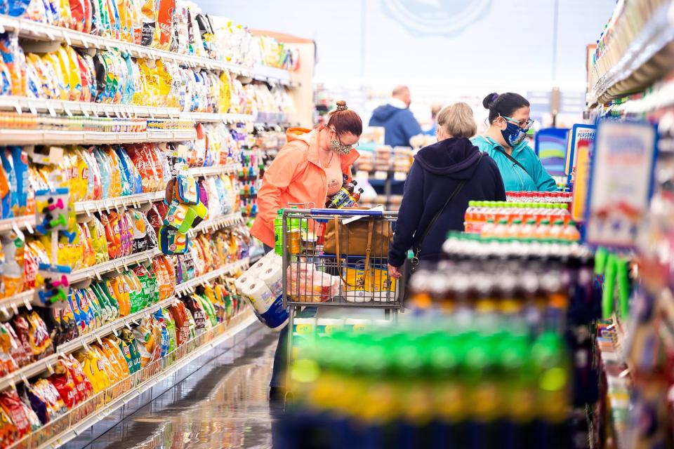 Customers shop at the new Food City store on Schaad Road in Knoxville on Wednesday, March 31, 2021. The 54,600+ sq. ft. supermarket held its grand opening on Wednesday. 
