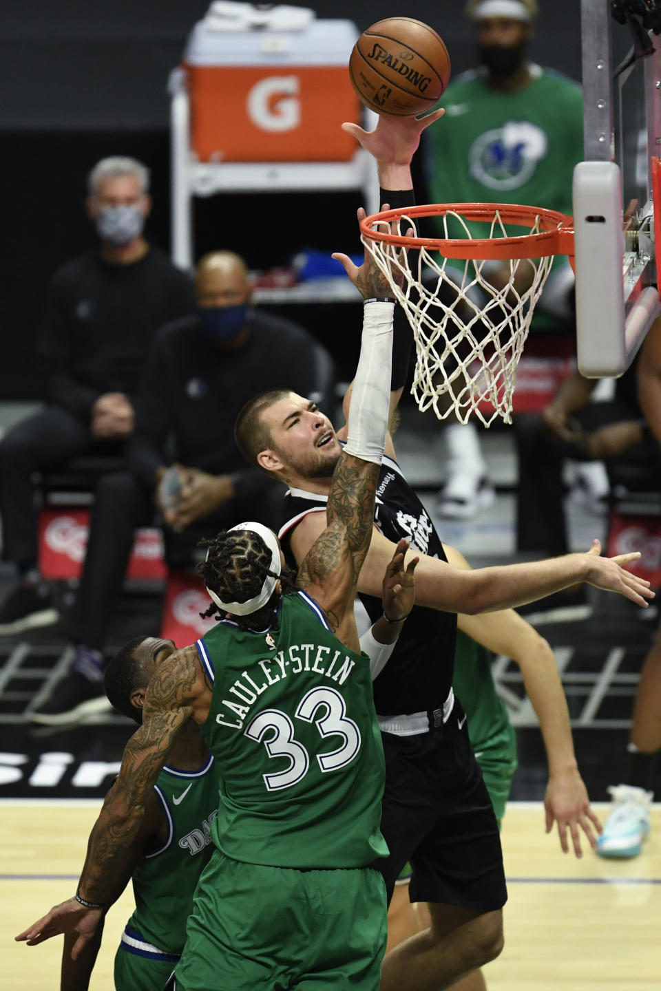 Los Angeles Clippers center Ivica Zubac, right, shoots over Dallas Mavericks center Willie Cauley-Stein during the second half of an NBA basketball game in Los Angeles Sunday, Dec. 27, 2020. (AP Photo/Kyusung Gong)