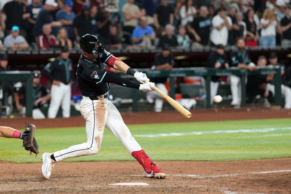 Arizona Diamondbacks shortstop Kevin Newman (18) hits a walk-off two RBI single against the Cincinnati Reds during the ninth inning at Chase Field in Phoenix on May 13, 2024.