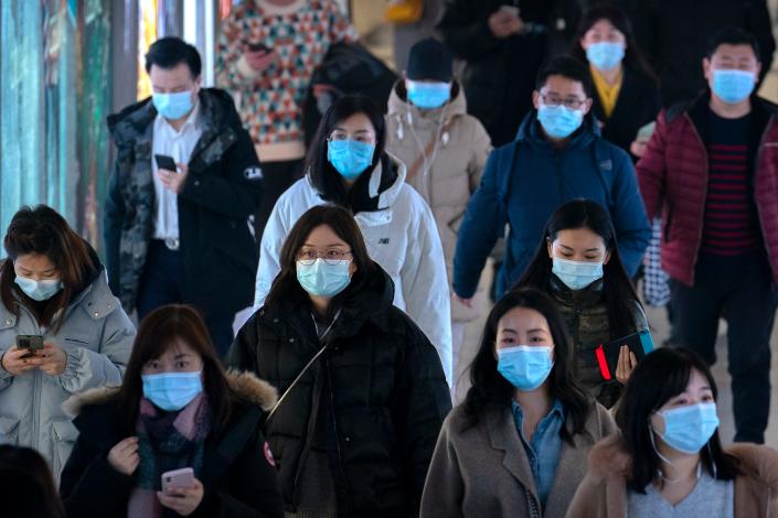 Commuters wearing face masks to protect against the spread of the coronavirus walk through a subway station in Beijing, Wednesday, March 3, 2021. China has been regularly reporting no locally transmitted cases of COVID-19 as it works to maintain control of the pandemic within its borders. 