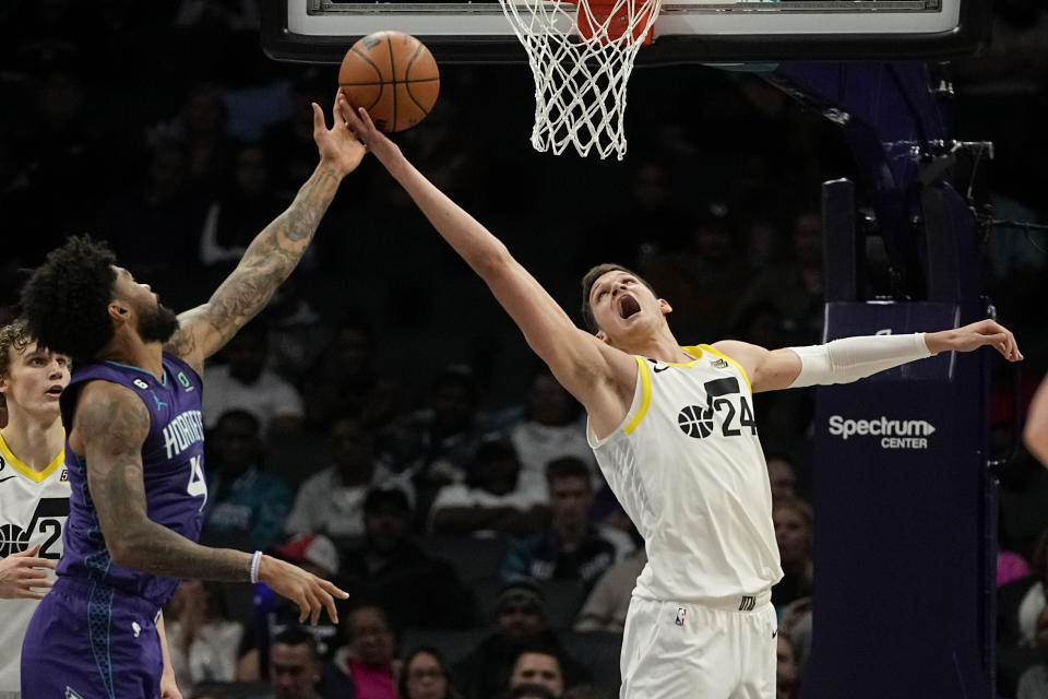 Charlotte Hornets center Nick Richards, left, vies for the ball with Utah Jazz center Walker Kessler during the first half of an NBA basketball game on Saturday, March 11, 2023, in Charlotte, N.C. (AP Photo/Chris Carlson)