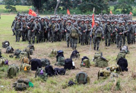 Members of the Philippine Marine Battalion Landing Team (MBLT) and Marine Special Operation Group (MARSOG) stands at attention in front of their belongings during their send-off ceremony ending their combat duty against pro-Islamic State militant groups inside a military headquarters in Marawi city, southern Philippines October 21, 2017, a few days after President Rodrigo Duterte announced the liberation of Marawi city. REUTERS/Romeo Ranoco