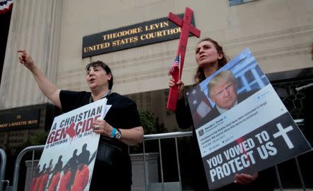 Protesters rally outside the federal court just before a hearing to consider a class-action lawsuit filed on behalf of Iraqi nationals facing deportation, in Detroit, Michigan, U.S., June 21, 2017. REUTERS/Rebecca Cook