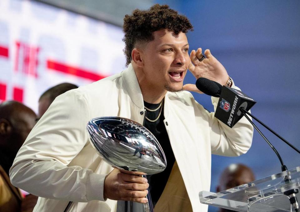 Kansas City Chiefs quarterback Patrick Mahomes eggs on the crowd while holding the Vince Lombardi Super Bowl Trophy during the NFL Draft outside of Union Station on Thursday, April 27, 2023, in Kansas City.