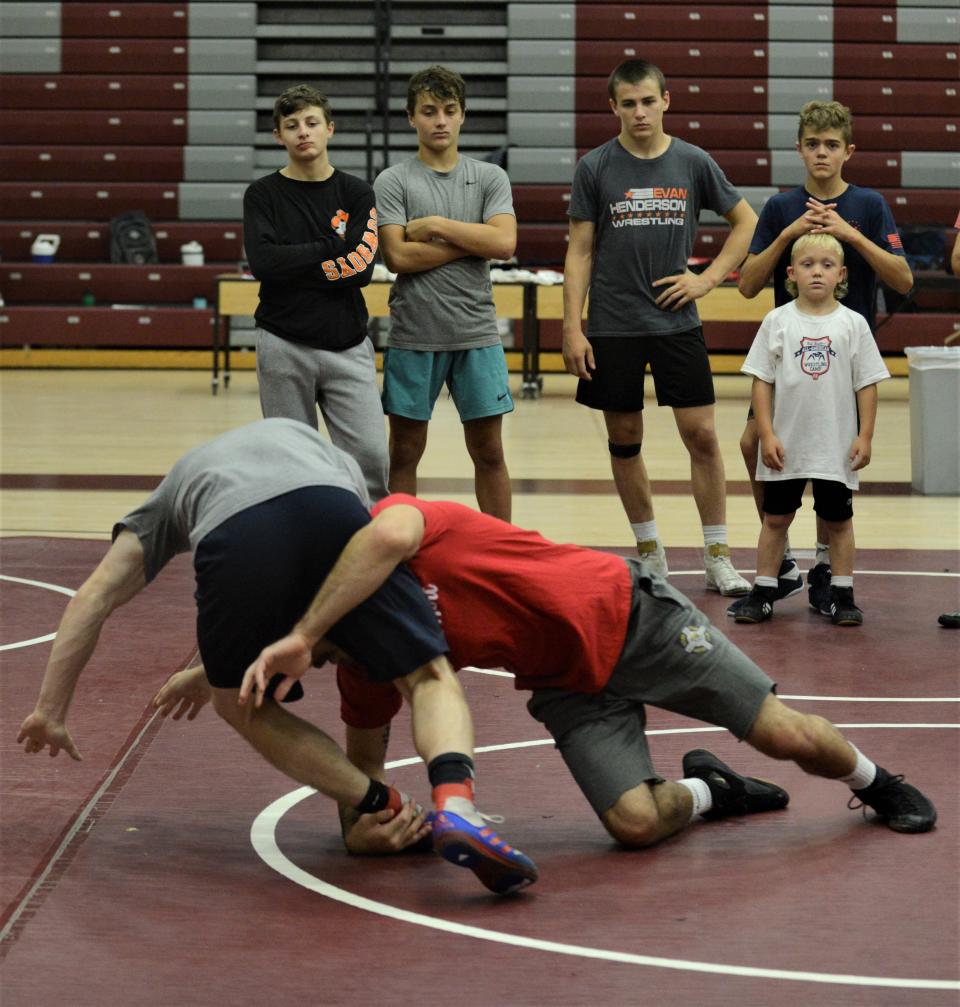 Two-time All-American Evan Henderson (red) works Nate Smith, also an All-American, during instruction at the Rob Waller All-American Camp, which was held on Wednesday and Thursday at John Glenn.