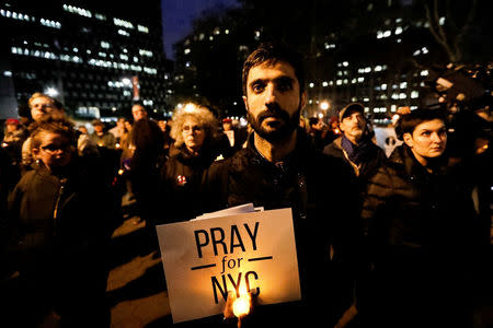 People gather for a candlelight vigil for victims of the pickup truck attack at Foley Square in New York City, U.S., November 1, 2017. REUTERS/Jeenah Moon