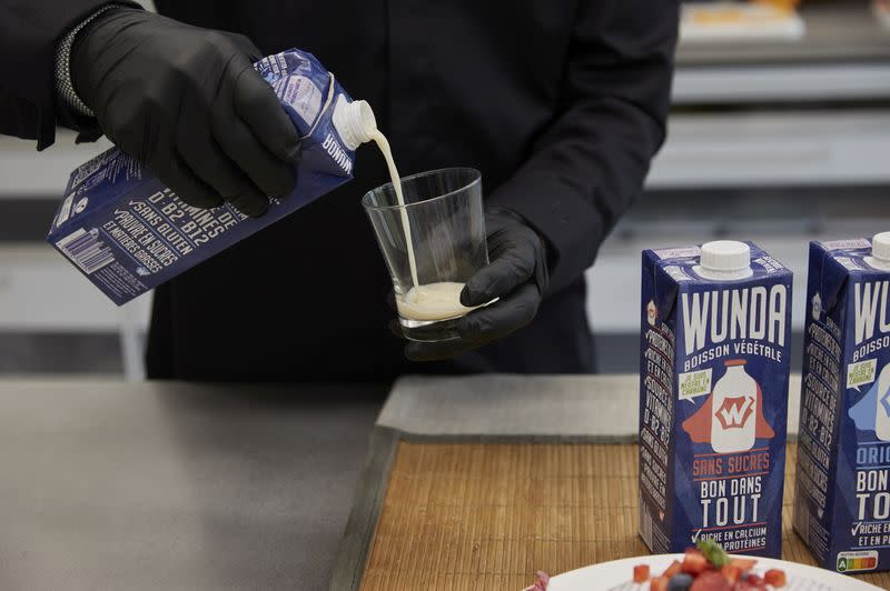 A staff pours Nestle new product a milk alternative made from yellow peas called "Wunda" in Lausanne