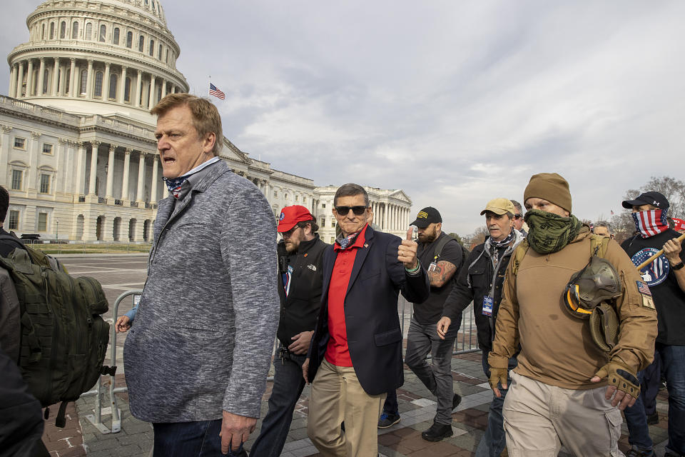 Flynn departs the Dec. 12, 2020, protest where he said Trump supporters trying to flip the election results were fighting &ldquo;a spiritual battle for the heart and soul of this country.&rdquo; (Photo: Tasos Katopodis/Getty Images)