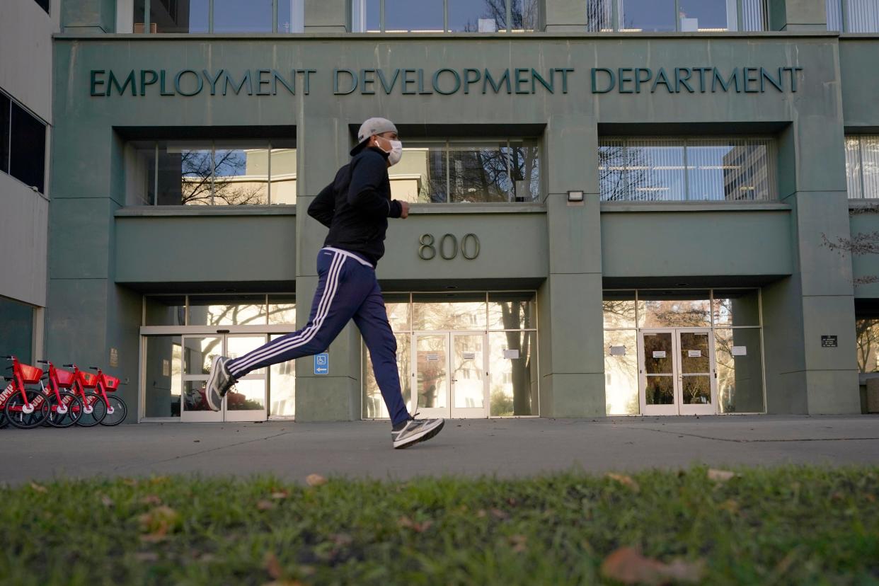 Aa runner passes the office of the California Employment Development Department (Copyright 2020 The Associated Press. All rights reserve)