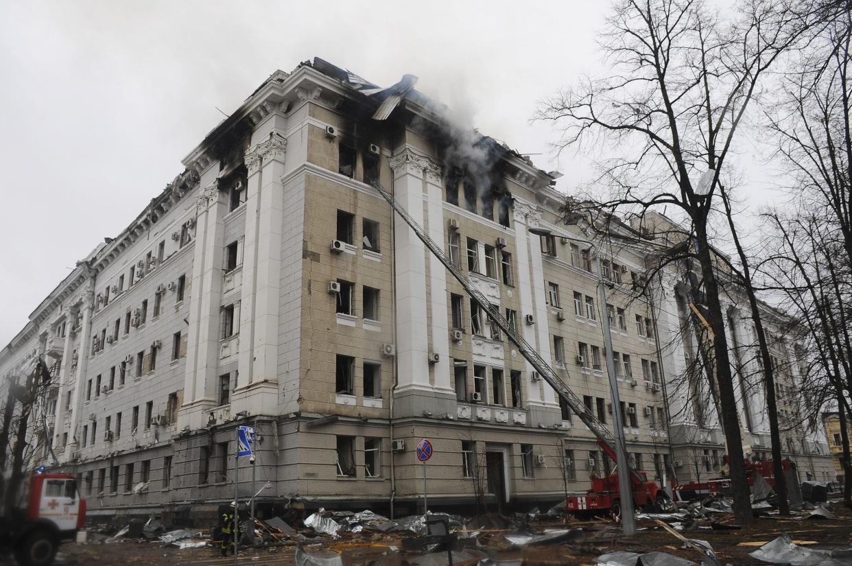Firefighters extinguish a building of Ukrainian Security Service (SBU) after a rocket attack in Kharkiv, Ukraine's second-largest city, Ukraine, Wednesday, March 2, 2022.