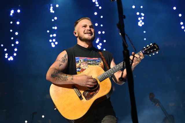 <p> Michael Buckner/Variety via Getty</p> Zach Bryan performs during a concert in Los Angeles in August 2023.