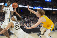 Akron's Ali Ali (24) Enrique Freeman (25) and Kent State's Magnus Entenmann, right, vie for the ball during the second half of an NCAA college basketball game in the championship of the Mid-American Conference tournament, Saturday, March 16, 2024, in Cleveland. (AP Photo/Phil Long)