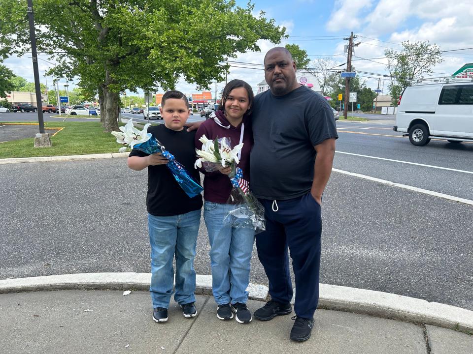 Eduardo Ocasio, a Vineland police officer, and his children Amanda and Noah brought flowers to the Deptford Township Police Department to pay tribute to Officer Bobby Shisler, who died Sunday from injuries sustained in the line of duty March 10.