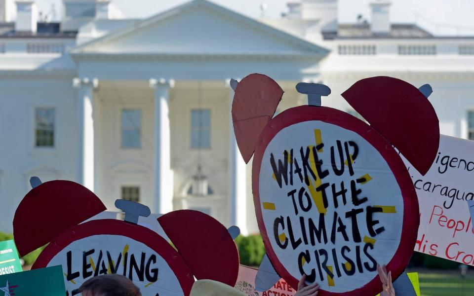 Protesters gather outside the White House in Washington to protest President Donald Trump's decision to withdraw the Unites States from the Paris climate change accord - Susan Walsh /AP