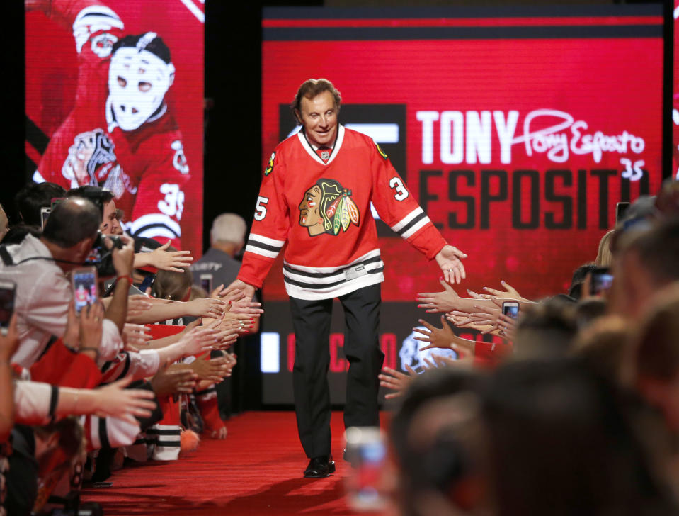 FILE - In this July 15, 2016, file photo, Chicago Blackhawks great Tony Esposito is introduced to the fans during the Blackhawks' convention in Chicago. Esposito, a Hall of Fame goaltender who played almost his entire 16-year career with the Blackhawks, has died following a brief battle with pancreatic cancer, the team announced Tuesday, Aug. 10, 2021. He was 78. (AP Photo/Charles Rex Arbogast, File)