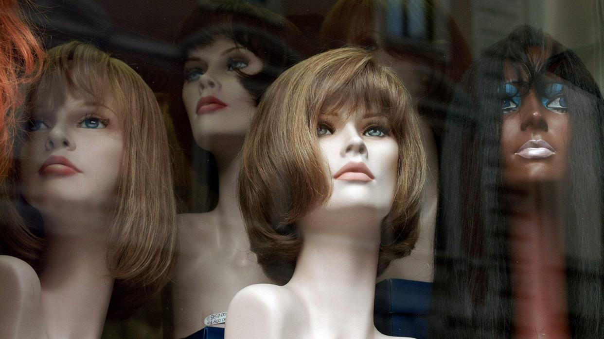 Display of mannequin heads with wigs