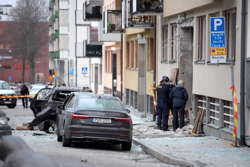 FILE PHOTO: Police work on the site where an explosion damaged a residential building in central Stockholm