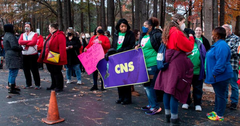 Educators, school support staff and their supporters rally outside the Wake County school board meeting in Cary, N.C. on Tuesday, Dec. 7, 2021 to call for higher pay. The school board is considering whether to ask for enough money to raise the minimum salary to $18 an hour for hourly staff.